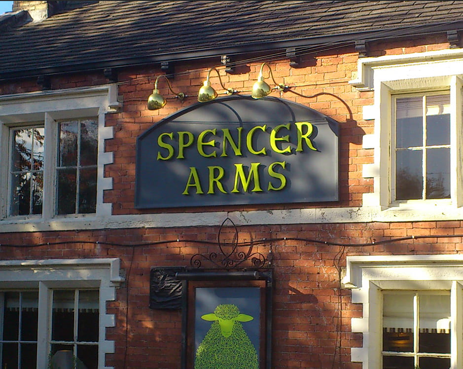 An image of signage at the Spencer Arms in Cawthorne.